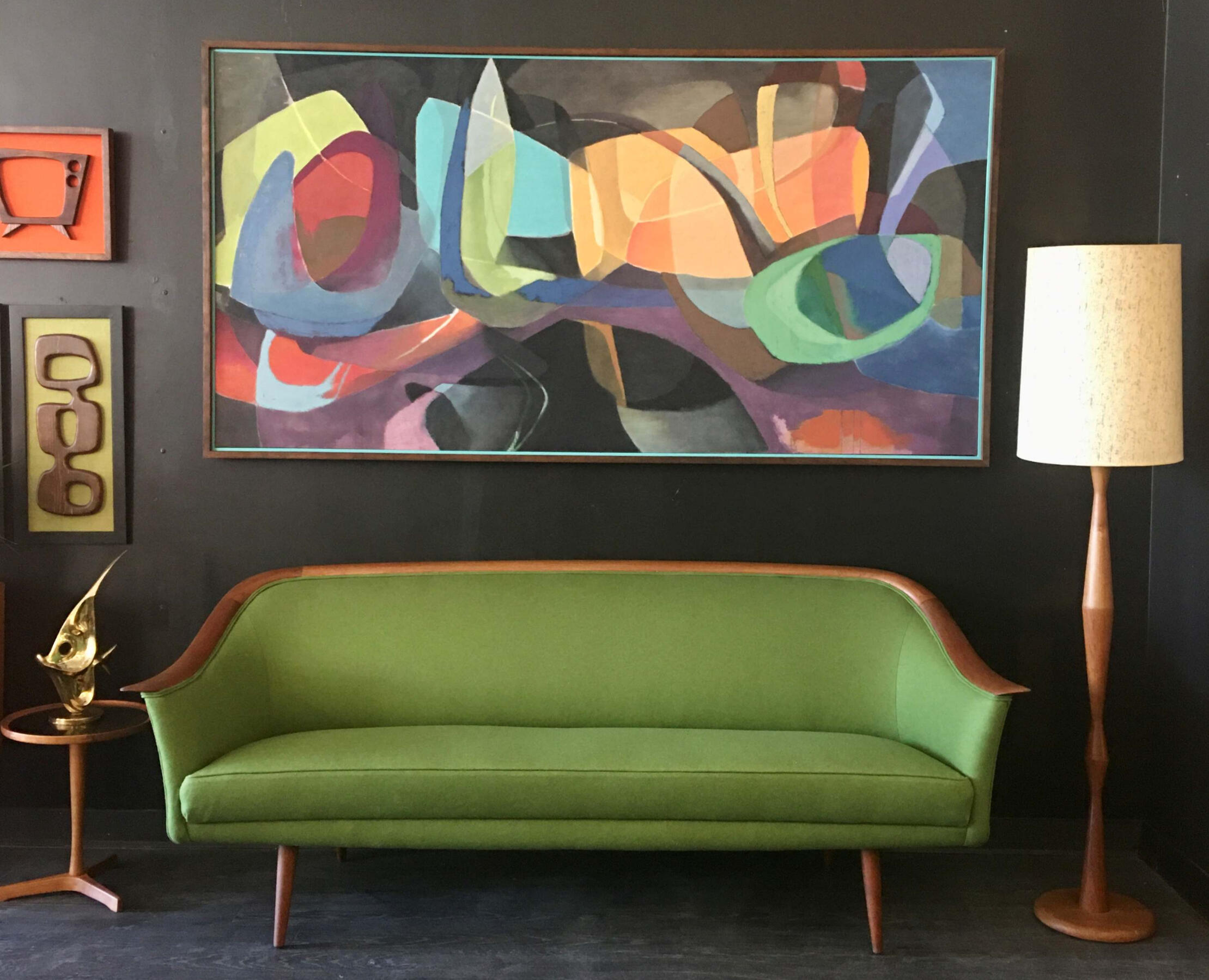 Mid‑century modern green upholstered sofa with wooden frame. Trusted mid-century buyers Mr. Mansifled Vintage lethbridge